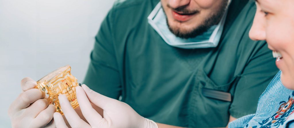 Cheapest All on 4 Dental Implants Abroad 2 dentist explaining dental implant procedure to pat 6JUFP58 min