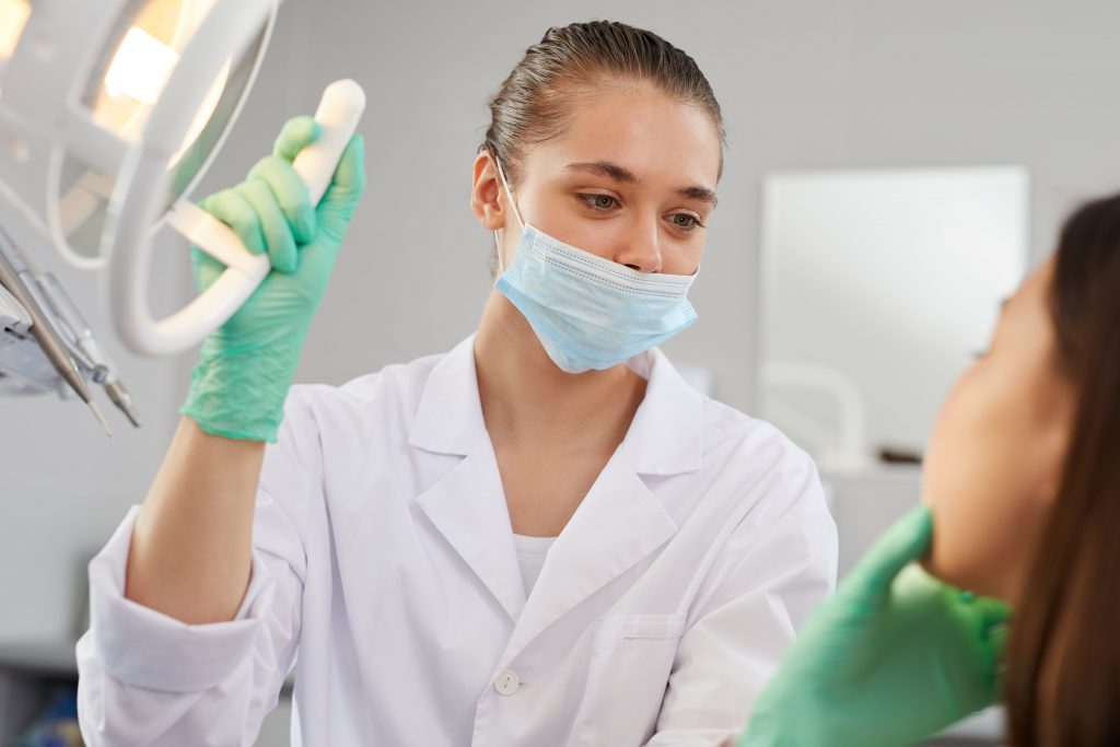 What are the Same Day Teeth Implant Advantages in Turkey? 2 female dentist examining patient 6QN7G2D min