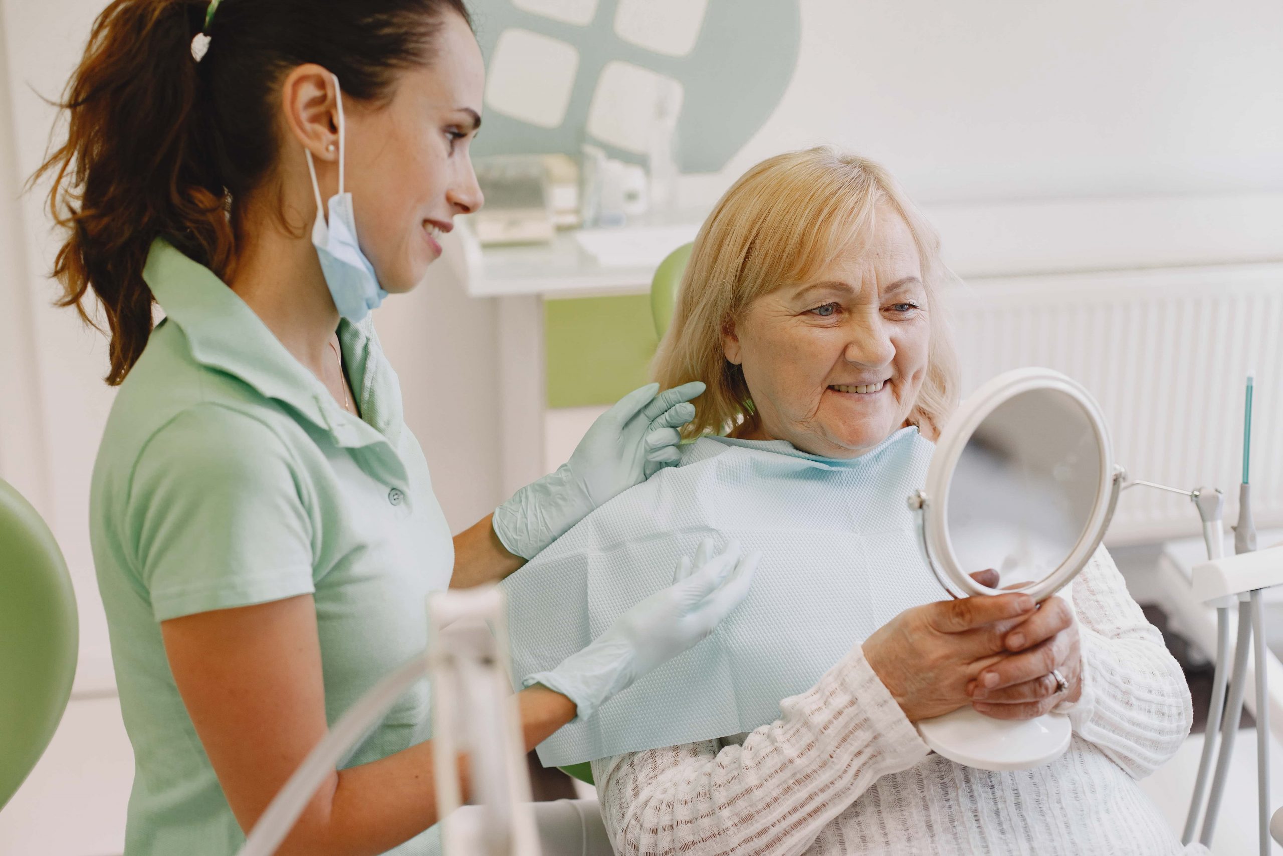 Which Implant is the Best for Teeth and Dental Health? 1 dentist looking her old patient with tools CLDHYYS min 1 scaled