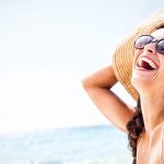 portrait of smiling woman on the beach JLJSSBV min