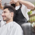 male-customer-looking-on-cutting-hair-XMGQ5D7-min