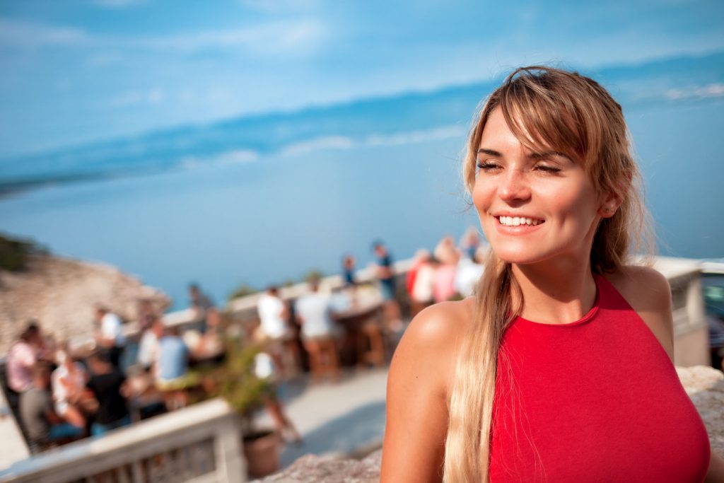 Smile Makeover Cost in Antalya, Turkey- High Quality Treatment 2 cute smiling young woman during vacation sitting o T6K2TSV min